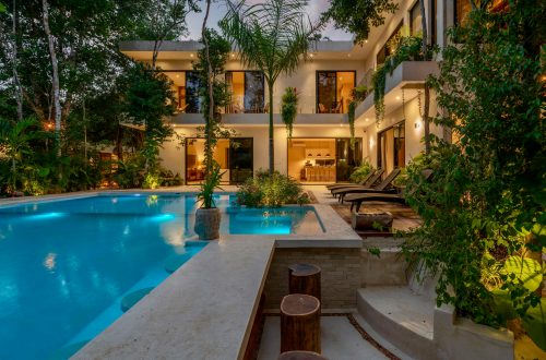 modern above ground backyard pool surrounded by plants and trees
